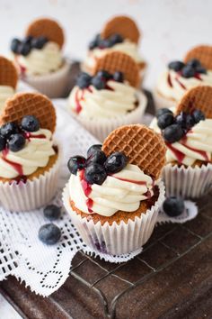 several waffle cups with blueberries and cream on top