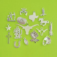 many different types of charms on a green surface