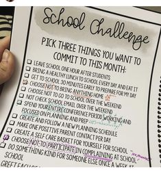 a hand holding a piece of paper that says school challenge pick three things you want to commit to this month