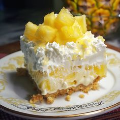 a piece of cake with pineapples on top is sitting on a white plate