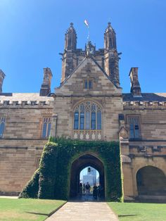 the entrance to an old castle with ivy growing on it