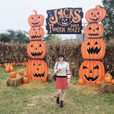 a woman is standing in front of pumpkins at jack's - o - lanterns