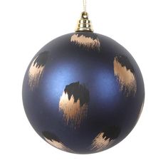 a blue ornament with gold designs hanging from a chain on a white background