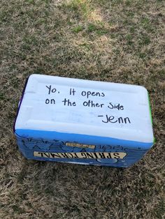 an ice chest sitting in the grass with writing on it that says yo, it opens on the other side