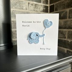 "Welcome the cute new baby in style with this typewriter font printed greeting card with crochet elephant applique holding a heart shaped balloon. Large square card for new parents. Image Phrase: 'Welcome to the World, Baby Boy' Personalise your message by typing your chosen phrase in the personalisation box. Inside left blank for your own message. You can choose the colour of the elephant & balloon from the drop down menus. If the colour of your choice isn't available simply choose 'other' and Crochet Elephant Applique, Elephant Balloon, Baby Congratulations Card, Baby Cards Handmade, Elephant Applique, Baby Elefant, New Baby Card, Congratulations Baby, Bunny Gifts