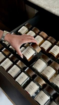 a woman's hand reaching for chocolates in a drawer