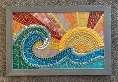 a mosaic tile artwork depicting the sun and ocean waves