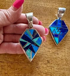 This beautifully well crafted Shield Pendant has been handmade by a Navajo Artisan. The Colors of the Pendant come from Lapis Lazuli, Turquoise and Blue Opal. The Pendant measures 2 1/8” long and 1 1/4” wide. These will vary in design due to natural stones. “Winds of Wisdom” (Lapis Lazuli, Turquoise and Blue Opal. The Navajo (Dine’) believe that the wind is a powerful source. The native tradition believes that at any moment, the blowing wind can inspire one with hope, resolve, and great wisdom. Unique Blue Necklace With Inlay, Southwestern Blue Necklace With Inlay, Southwestern Blue Inlay Necklace, Artisan Blue Inlay Necklaces, Southwestern Style Blue Inlay Necklace, Blue Southwestern Jewelry With Large Pendant, Southwestern Style Blue Jewelry With Large Pendant, Artisan Blue Jewelry With Inlay, Handmade Southwestern Blue Jewelry