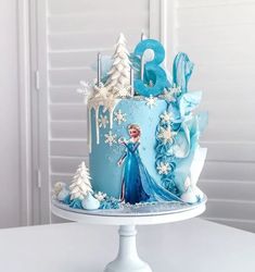 a frozen princess birthday cake with frosting and icing decorations on a white table