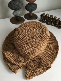 a brown hat sitting on top of a white table