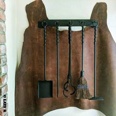 there is a broom and other items hanging on the wall