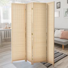 the room divider is made out of bamboo and sits in front of a couch