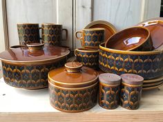 an assortment of ceramic dishes and cups on display