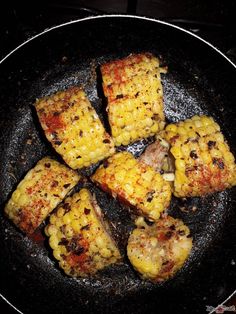 corn on the cob is being cooked in a skillet with some seasoning