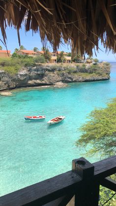 two boats floating in the clear blue water