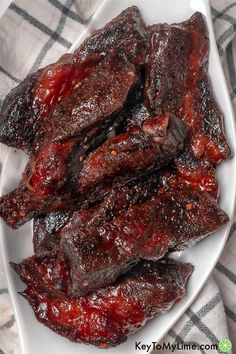 barbecue ribs with bbq sauce on a white plate