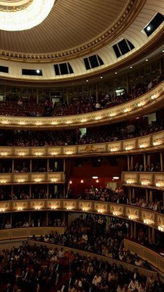 an auditorium filled with lots of people and lights