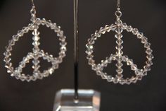 I created these Swarovski clear crystal Peace Sign Earrings as a celebration of life (or maybe my inner hippie). They just make you smile wearing them!! I use sterling earwires with stoppers. If you prefer sterling posts or leverbacks, please be in touch with me. Your earrings will be presented in a silver earring gift box. Nickel Free Clear Jewelry For Party, Nickel-free Clear Jewelry For Parties, Nickel-free Crystal Earrings For Party, Nickel-free Round Crystal Earrings For Party, Hypoallergenic Crystal Earrings For Party, Handmade Sterling Silver Crystal Earrings For Party, Nickel-free Crystal Earrings For Anniversary, Nickel-free Clear Round Crystal Earrings, Nickel Free Sterling Silver Clear Crystal Earrings