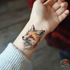 a small fox tattoo on the wrist