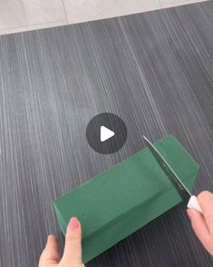 someone cutting paper with a pair of scissors