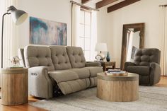 a living room with two recliners and a round coffee table in the middle