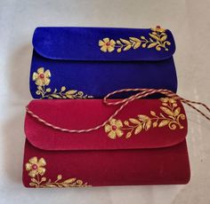 Embroidered by hand, our elegant clutch bags will shine among your party essentials. Made from velvet, the luxurious feel of these bags is only matched with the beautiful embroidery done with gold thread and red beads. You can add a dash of glamour to your evening outfit or brighten up your casual day look. The inside of this purse is lined in faux silk for the smaller essentials. Hand made in the north of India by women, this facility provides employment to artisan communities. The working conditions are clean and a sense of community prevails within the group.  Boho Homes London is a furniture and decor specialist creating unique handmade home decor products for your home Velvet Rectangular Evening Bag For Wedding, Velvet Pouch Bag For Gifts, Velvet Pouch Bag As Gift, Velvet Pouch Bag For Gift, Embroidered Velvet Bags Ideal For Gifts, Embroidered Velvet Bag For Gifts, Embroidered Velvet Bag Perfect For Gifts, Gold Velvet Bag For Gifts, Velvet Evening Bag As A Gift