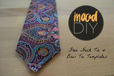 the neck tie is purple and blue with paisley designs on it, along with an orange tag that says macd diy