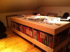 a table with many books on it in the middle of a room