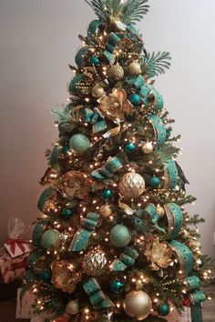 a decorated christmas tree with blue and gold ornaments