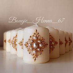 there are candles with pearls on them sitting next to each other in front of the words bougie henna 6