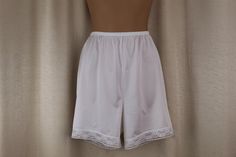 White short pettipants/sleep shorts  by Vanity Fair Good condition Tag size Medium but will fit size small as well. Please see Measurements below 100% Nylon Good condition light wear no damage Waist: 24-30" Hips: up to 37" Length from waist to hem: 16" Rise from top of waist to crotch: 14" We offer a fair return policy. See policies for details. ♥*-.,.--.,.--.,.--.,.--.,.--.,.-* ♥*-.,.--.,.--.,.--.,.--.,.-*♥ Fitted Shorts With Short Inseam For Daywear, Stretch Lace Trim Shorts For Daywear, White Fitted Pajama Shorts, Stretch Lace Trim Pajama Shorts, Fitted Pajama Shorts With Elastic Waistband, Stretch Pajama Shorts For Daywear, Summer Daywear Bottoms Mid-thigh Length, Fitted Short Bottoms, Stretch Shorts With Short Inseam For Daywear