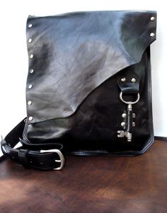 Black Leather Messenger Bag with Antique by UrbanHeirlooms on Etsy Black Leather Punk Shoulder Bag, Black Gothic Leather Shoulder Bag, Punk Leather Shoulder Bag With Gunmetal Hardware, Black Steampunk Bags With Rivets, Gothic Black Shoulder Bag With Rivets, Black Gothic Shoulder Bag With Rivets, Steampunk Black Bag For Alternative Fashion, Punk Leather Bags With Rivets, Leather Bag With Rivets For Concerts