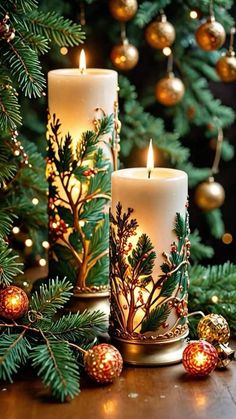 two candles sitting on top of a table next to a christmas tree