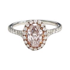 an oval shaped pink and white diamond ring