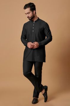 Black cotton silk short shirt kurta with pintucked mandarin collar, sleeve borders and patch pocket.
Components: 1
Pattern: Plain
Neckline: Mandarin Collar
Sleeve Type: Full Sleeves
Fabric: Cotton Silk
Color: Black
Other Details: 
Side pockets on kurta
Model height: 5ft 6inches, wearing size S
Closure: Front button placket
Note: The pant worn by the model is not for sale
Occasion: Mehendi and Puja - Aza Fashions Formal Long Sleeve Kurta With Set-in Sleeves, Traditional Semi-formal Kurta With Buttons, Black Kurta For Workwear And Eid, Long Sleeve Kurta With Button Cuffs For Workwear, Fitted Stand Collar Kurta For Workwear, Traditional Long Sleeve Kurta With Pintucks, Fitted Kurta With Stand Collar For Workwear, Traditional Nehru Jacket With Stand Collar For Work, Cotton Kurta For Work And Eid