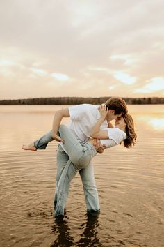 a man holding a woman in the water