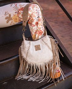 Experience the luxurious full grain leather of the STS Cremello Nellie Fringe Bag, expertly crafted to reveal a soft tanned suede under crust. The intricate buck stitch and threaded accents add a touch of rustic charm. Complete your wardrobe with this perfect combination of style and quality. Features Soft, genuine leather exterior Zip top closure Removable suede leather carry strap 1 exterior magnetic snap closure pocket; 1 interior zip pocket "Peace comes from within" quote inside STS embossed Pendleton Throw, Horse Hair Bracelet, Hair Bracelet, King Size Blanket, Queen Size Blanket, Native American Bracelets, Upcycled Bag, Native American Necklace, French Jewelry