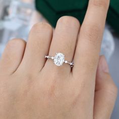 a woman's hand with a diamond ring on it