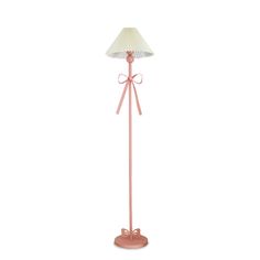 a pink floor lamp with a bow on it