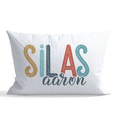 a pillow with the words slas aaron printed in multicolored letters on it