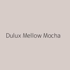 the words dulux mellow mocha are in black and white on a gray background