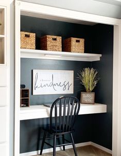 a black chair sitting in front of a white shelf filled with baskets and boxes on top of it