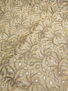 "Gold color embroidery on gold shantung fabric 54\" wide. Usable of apparel,accessories and interior designing." Fabric Print Design, Color Embroidery, Silk Fabrics, Interior Designing, Fabric Suppliers, Fabric Beads, Embroidery Suits, Fabric Sale, Hand Beading