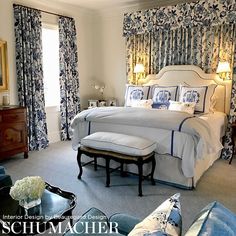 a large bedroom with blue and white decor