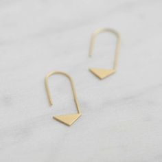 . Trendy . Minimal . Unique . Inspired by geometry, These triangle thread earrings are comfortable to wear everyday adding a modern touch to your casual look. Also the best gift for girls who loves design!  :: Material > sterling silver / yellow gold filled=sterling silver coated with 5 micrometers thick of 22k yellow gold.  :: Finish > matte  :: Approx. Measurements > Height 38mm / Width 12mm / Stick diameter >> 1mm :: This item is hand fabricated by us spe... Gold Triangle Minimalist Earrings, Minimalist Gold Triangle Earrings, Minimalist Triangle Jewelry For Pierced Ears, Minimalist Triangle Hoop Earrings As Gift, Minimalist Triangle Earrings For Everyday, Minimalist Nickel-free Triangle Earrings, Minimalist Triangle Nickel-free Earrings, Matte Gold Earrings, Earrings Triangle