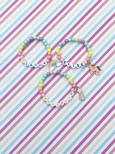 Adorable kids beaded bracelet with 6mm pastel iridescent rainbow beads with your choice of name/lettering and charm. So cute and the charm adds such a unique look to your little one's bracelet! You can also choose not add a charm and just a name/word. Makes a great gift as well- everyone loves something personalized! Please provide the following information in the personalization field: -Name/word you would like -Heart color (if any)- red, orange, yellow, green, blue, purple, pink, black or gold Cute Beaded Bracelets For Personalized Gifts, Personalized Rainbow Beaded Bracelets, Personalized Rainbow Beaded Bracelets Cute Style, Personalized Rainbow Beaded Bracelets For Birthday, Personalized Rainbow Beaded Bracelet For Birthday, Personalized Cute Rainbow Beaded Bracelets, Personalized Adjustable Rainbow Beaded Bracelets, Cute Personalized Rainbow Beaded Bracelets, Personalized Cute Rainbow Bracelets