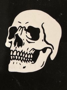 a white and black sticker with a skull on it's face is shown