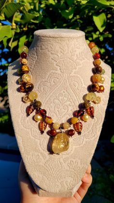 Mahogany colored skies, a season of change, and golden sunlight.  This necklace is made with the intention of bringing the feeling of fall to life.  Made with a free form stainless steel wire wrapped citrine pendant, garnet spacers, yellow aventurine, mookaite jasper, blood amber, owyhee jasper, golden prehnite, czech glass, rosewood, freshwater pearls, and stainless steel.  Length: about 20 inches with a 4 inch extender If a longer extender chain is needed, please leave a note for me upon check out or feel free to message me directly ! Season Of Change, Yellow Aventurine, Mahogany Color, Mookaite Jasper, Citrine Pendant, Citrine Necklace, Stainless Steel Wire, Czech Glass, Citrine