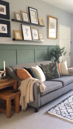 a living room filled with furniture and pictures on the wall