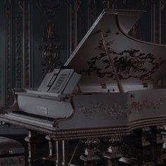 a grand piano in an ornately decorated room